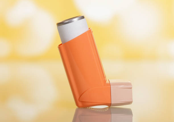 Portable pocket inhaler for asthmatics, on yellow background