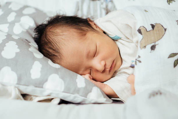 istock Little baby lying on bed at night. 874899798