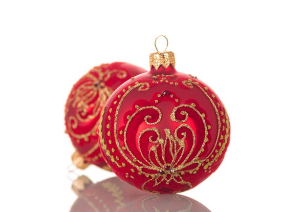 istock Bright red Christmas toy ball decorated with gold pattern isolated on white 874900080