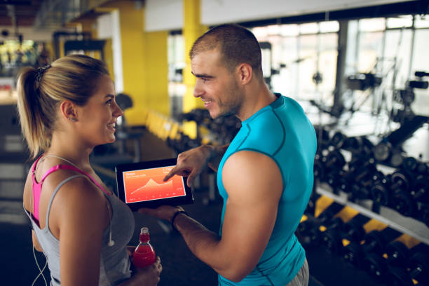 istock Trainer explaining workout regime to woman 874903736