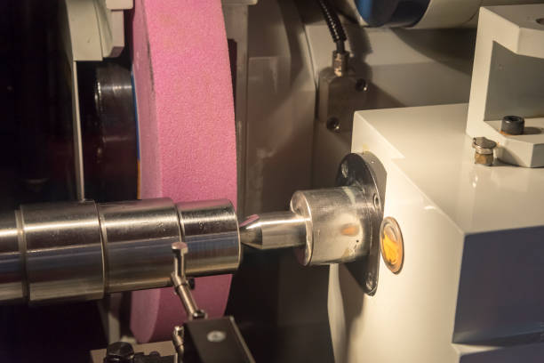 istock The cylindrical grinding machine with the steel shaft. 874907822