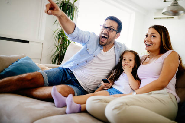 istock Happy family watching television at their home 874911202