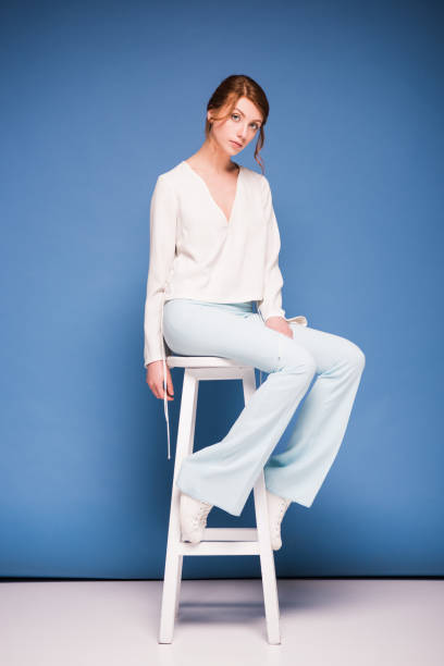 istock beautiful woman sitting on chair 874911642
