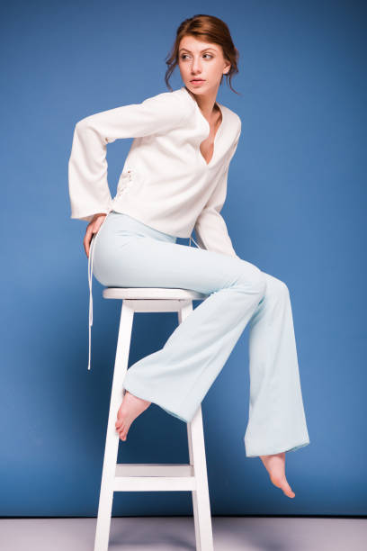 istock beautiful woman sitting on chair 874914264