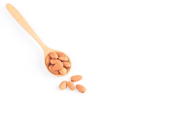 istock Almonds,Almonds on wooden spoon isolated over white background 874915242