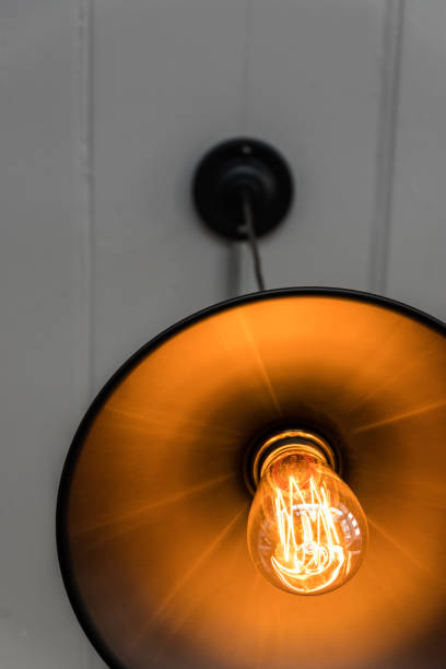 istock Close up of filament inside warm light bulb with lam 874918746