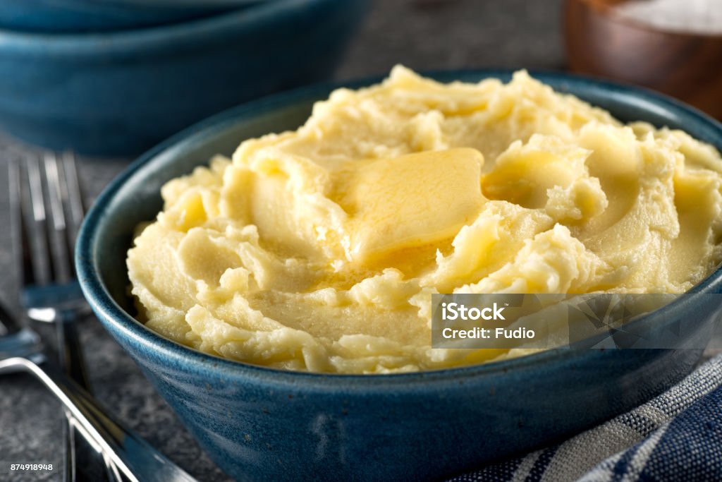 Mashed Potatoes with Melted Butter A bowl of delicious mashed potatoes with melted butter. Mashed Potatoes Stock Photo