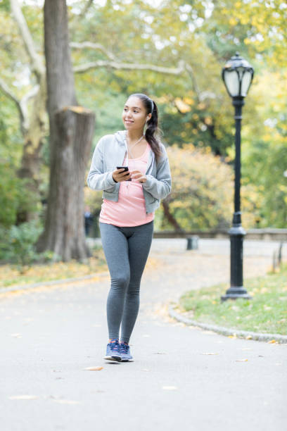 istock Active young woman walks in Central Park 874922452