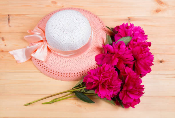 istock Bunch of peonies and hat. Top view 874923042