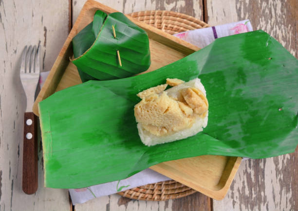 istock Sticky rice with egg custard wrap with banana leaf 874925988
