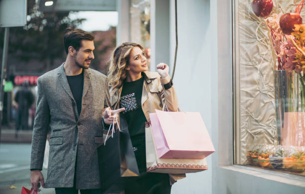 istock Couple passing beside shopping window 874932142