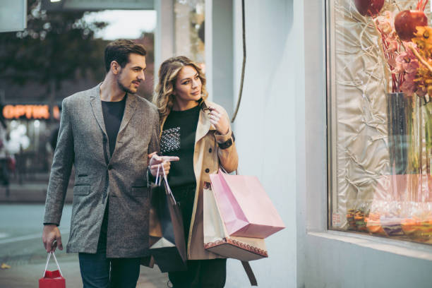 istock Couple looking at the shopping window 874932202