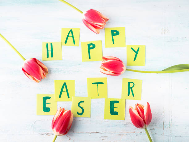 istock Happy Easter background tulips flowers hand written letters 874932424
