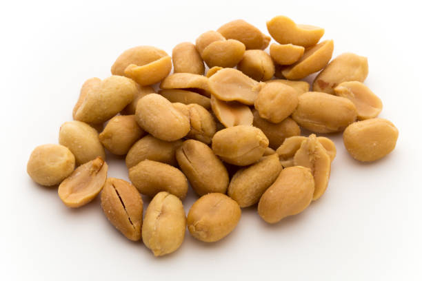 istock Peeled peanuts on the isolated background. 874933694