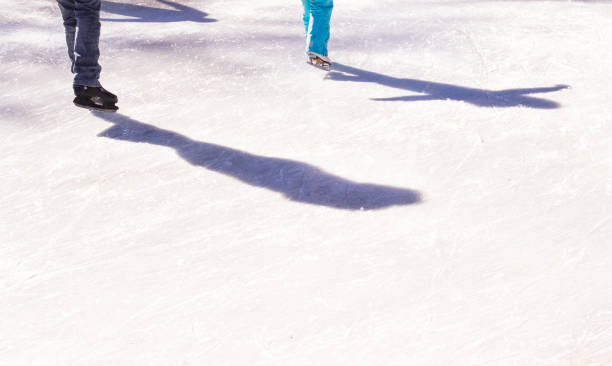 istock Shadows of skaters on ice rink 874934300