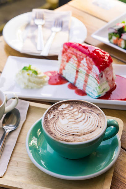 istock coffee mocha lattee cup on wood table and cake relax time on cafe shop 874937128