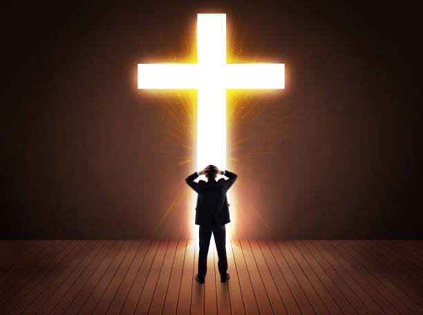 istock Man looking at bright cross sign 874951530