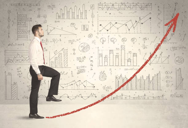 istock Business man climbing on red graph arrow concept 874959034