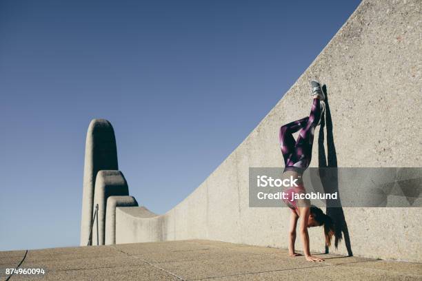 Fit Woman Doing Hand Stand Outdoors Stock Photo - Download Image Now - Handstand, Females, Wall - Building Feature