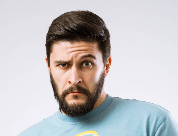 Facial expressions Portrait of surprised doubtful bearded man sheepish look stock pictures, royalty-free photos & images