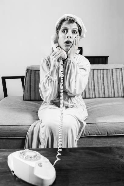 istock 1960's woman gossips on the phone while sitting in her robe 874969988