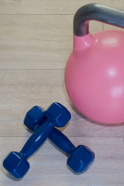 istock Blue dumbbells and pink kettlebell 874973466