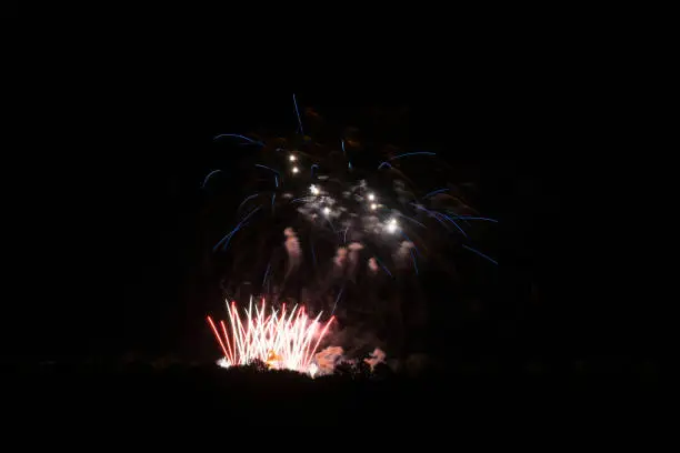 Many blue rockets of fireworks flying through the air and exploding beautiful