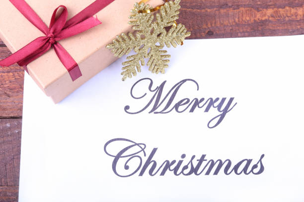 istock Text merry christmas on paper with many balls and gift boxes 874979310