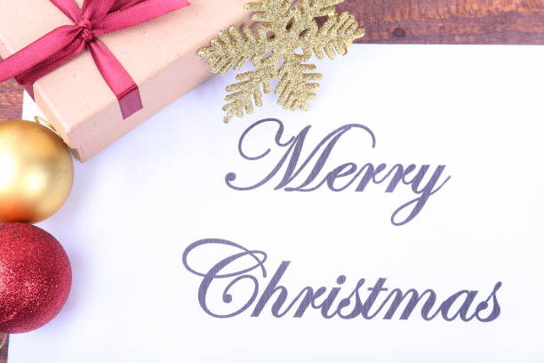 istock Text merry christmas on paper with many balls and gift boxes 874979352