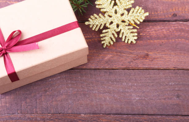 istock Gift boxes with bow and christmas decoration on wood background 874979598