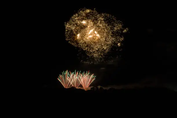 Breathtaking explosion of fireworks looking like a galaxy or milky way in orange colours