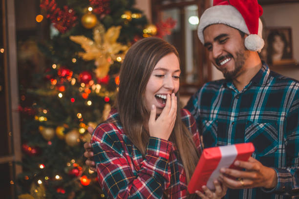 istock Young man giving gift to his girlfriend 874982706