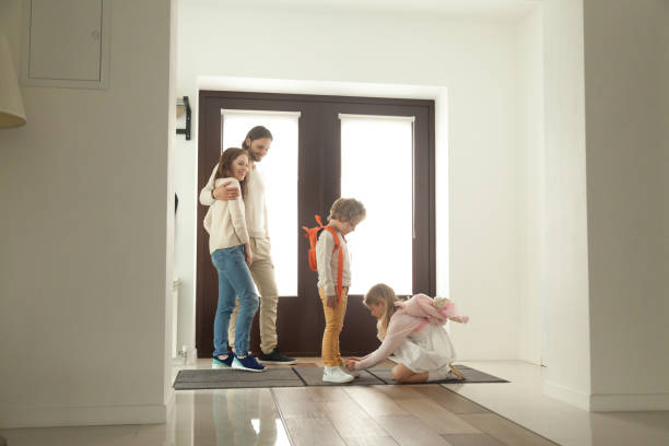 istock Little sister helping brother tying shoes, getting ready for walk 874986552