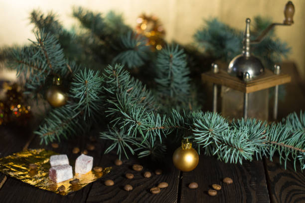istock Coffee grinder, coffee beans and Christmas tree branch on a wooden table 874987514
