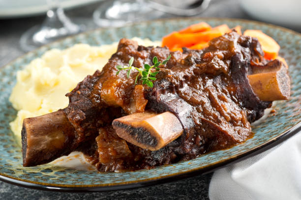 Braised Beef Short Ribs Delicious braised beef ribs with mashed potato and carrots. braised stock pictures, royalty-free photos & images