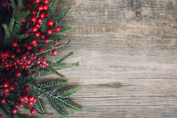 istock Christmas Evergreen Branches and Berries Over Wood 874990834