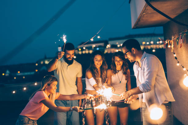 istock Group of happy friends celebrating at rooftop 874991846