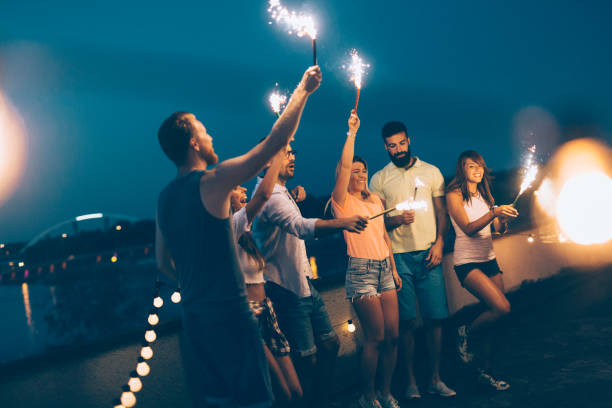 istock Group of happy friends celebrating at rooftop 874991916