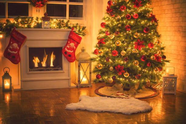 Christmas Tree Near Fireplace at Home Christmas tree near fireplace in decorated living room red poinsettia vibrant color flower stock pictures, royalty-free photos & images