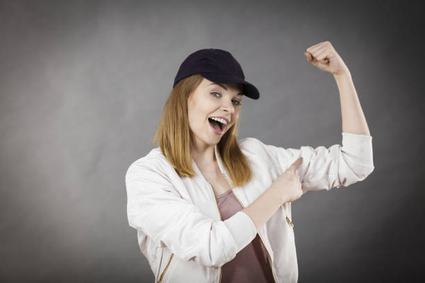 istock Young woman showing her arm muscles 875000538