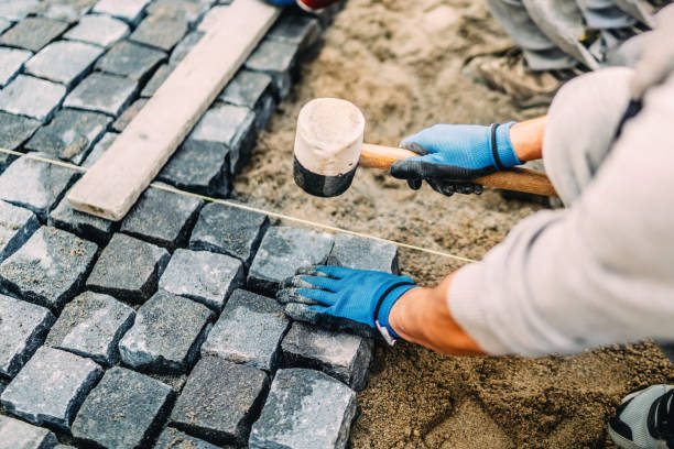 Construction worker installing stone on pavement. Details of construction site Construction worker installing stone on pavement. Details of construction site pavement ends sign stock pictures, royalty-free photos & images