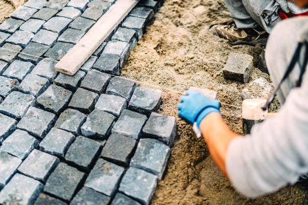 istock Construction worker details.Building of road or sidewalk with granite stone as pavement 875003994
