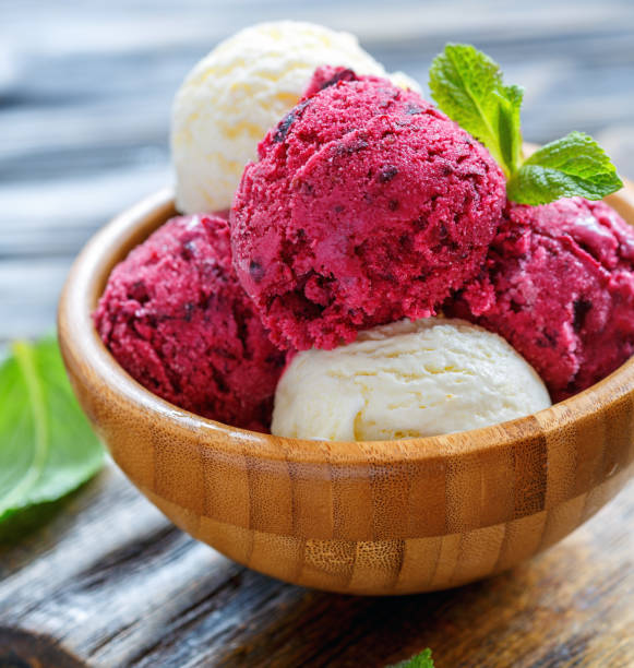 istock Lemon and blackcurrant ice cream in a wooden bowl. 875004450