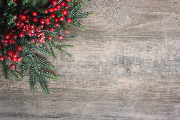 istock Christmas Evergreen Branches and Berries in Corner Over Wood 875004850