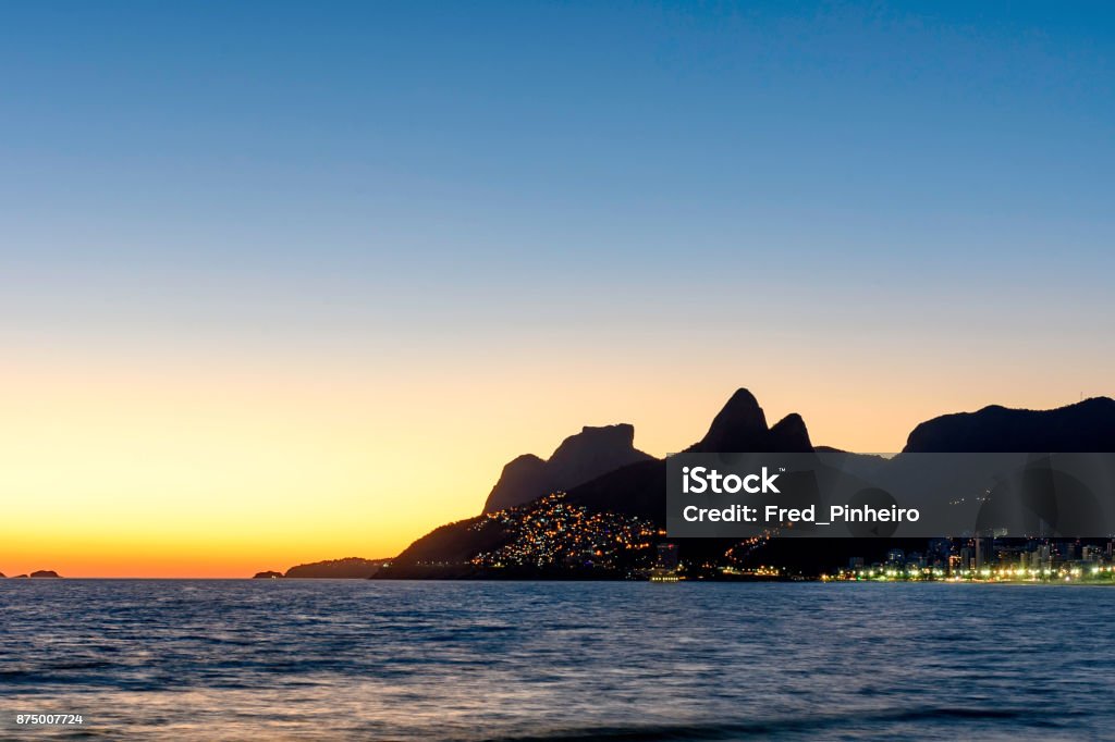 Night arriving at the Arpoador stone, Ipanema beach in Rio de Ja Night arriving at the Arpoador stone, Ipanema beach in Rio de Janeiro Pedra da Gavea Stock Photo