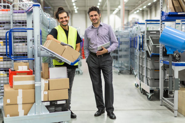 istock Businessman and male worker in distribution warehouse 875008150