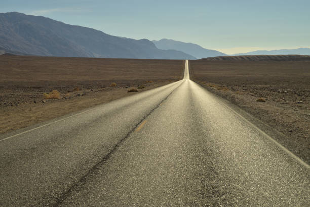 istock long empty desert road in Death Valley National Parl 875010986