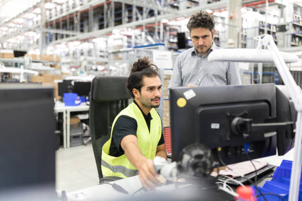 Warehouse employees using computer Warehouse worker working on computer with manager. Employees of the warehouse using computer. warehouse office stock pictures, royalty-free photos & images