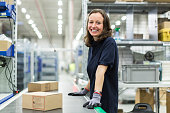 Woman working in large distribution warehouse