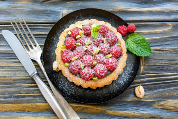istock Delicious raspberry tartlets with ganache of dark chocolate. 875014172
